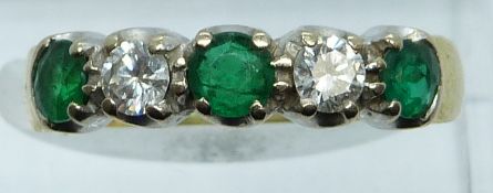 An 18ct gold ring set with diamonds and emeralds of approximately 0.2ct, 4.3g, size O