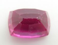 A loose cushion cut pink sapphire measuring approximately 9.8ct