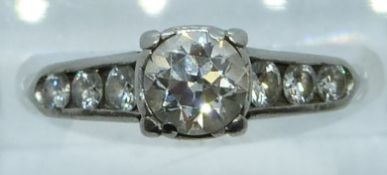 A platinum ring set with a diamond of approximately 0.65ct and six further diamonds to the