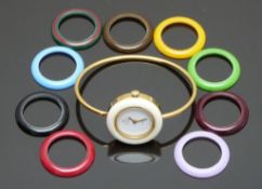 Gucci gold plated ladies wristwatch with gold hands, white dial and ten interchangeable bezels of