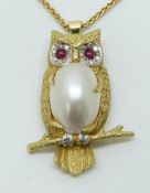 An 18ct gold owl pendant set with ruby eyes, diamonds and mother of pearl by E.W and Co. on 18ct