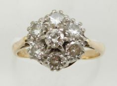An 18ct gold ring set with seven diamonds in a cluster, total weight approximately 1.35ct, 3.8g,