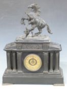 19thC black slate mantel clock in the Greek architectural style with apex top and reeded columns