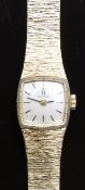 Omega 9ct gold ladies wristwatch with black hands and baton markers, silver dial and signed