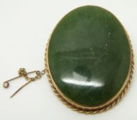 A 9ct gold brooch set with a large nephrite jade panel, 4 x 5cm