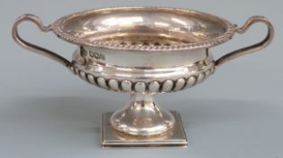 George V hallmarked silver twin handled novelty miniature vase or wine cooler with lobed lower body,