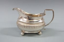 Georgian hallmarked silver cream or milk jug with gadrooned edge and part lobed body, London 1810,