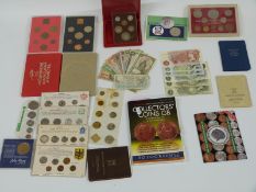 A collection of coin presentation packs, UK and overseas, a 2011 collector's coin book, banknotes