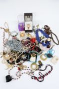 A collection of costume jewellery including beads, earrings, Anne Klein watch, glass beads etc