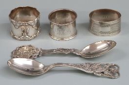 Three various hallmarked silver napkin rings and two Danish silver spoons, both by A.Michelsen of