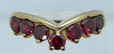 A 9ct gold ring set with garnets in a V setting, 5.2g, size O