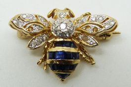 An 18ct gold bee brooch set with sapphires, diamonds and ruby eyes, 3.9g