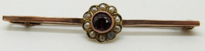 A 9ct gold brooch set with a garnet and seed pearls, 5cm