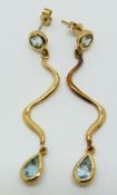 A pair of 9ct gold earrings set with a round and pear cut aquamarine to each, 4.3g