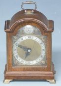 Elliott mantel clock in arched mahogany case, the silvered Roman chapter ring on bronzed dial with