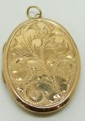 A 9ct gold locket with engraved floral decoration and engine turned back, 17.7g
