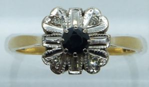 An 18ct gold ring set with a sapphire and diamonds in a platinum setting, 3.5g, size N