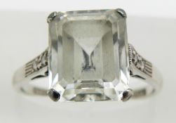 An 18ct gold ring set with an emerald cut white sapphire and diamonds, marked Parsons, 3.9g, size N