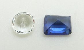 A loose round cut white sapphire and a rectangular step cut synthetic sapphire measuring