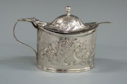Georgian hallmarked silver mustard pot with embossed decoration and blue glass liner, London 1804