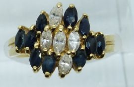 An 18ct gold ring set with marquise cut sapphires and diamonds, 5.3g, size K