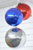 Three glass witch's balls or oversized baubles, diameter of largest approximately 28cm