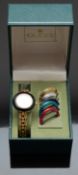 Gucci gold plated ladies wristwatch with gold hands, white dial and six interchangeable bezels of
