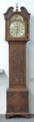 A 19thC English oak 8-day duration longcase clock with carved decoration, the silvered Roman