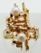 A 9ct gold ring set with two pearls in a bespoke design, 4.1g, size I/J