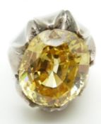 A large silver dress ring set with a large oval cut treated topaz
