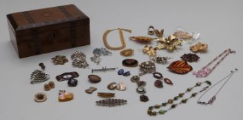 A collection of brooches including an Arts and Crafts example set with a moonstone, Hollywood,