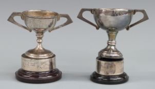 Two hallmarked silver trophy cups on stands, each approximately 10cm tall, weight without stands