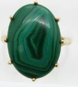 A 9ct gold ring set with a malachite cabochon, 4.5g, size K/L
