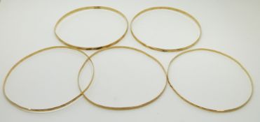 Four 14ct gold bangles with cut out decoration, 13.3g