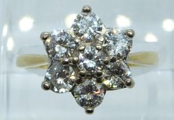 An 18ct gold ring set with a cluster of diamonds, the central diamond of approximately 0.17ct and