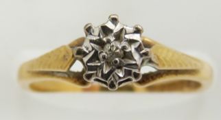 An 18ct gold ring set with a diamond in an illusion setting, 2.7g, size J/K