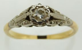 An 18ct gold ring set with a diamond in a platinum setting, 2.9g, size O/P