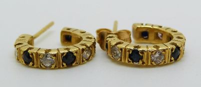 A pair of yellow metal hoop earrings set with alternating diamonds and sapphires, 4.5g