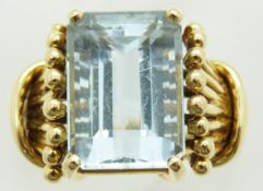 An 18k gold ring set with an emerald cut aquamarine, bought from Brazil, 7.2g, size K