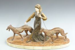Art Deco figurine of a lady walking two hunting dogs, possibly R Scali, raised on a two tone