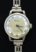 Accurist 9ct gold ladies wristwatch with black hands and Roman numerals, gold dial and 21 jewel