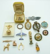 Six 9ct gold charms/ pendants comprising horseshoe, windmill, poodle, fish, football and a heart,