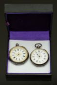 Two silver ladies pocket watches both with black Roman numerals, white dials and engraved cases