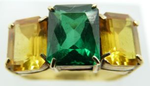 An 18ct gold ring set with emerald cut topaz and two synthetic yellow sapphires, 4.6g, size M