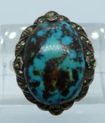 A 9ct gold and silver ring set with turquoise and marcasite, 6.1g, size L