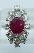 An 18ct white gold ring set with a 2.26ct natural untreated oval ruby surrounded by 14 round cut