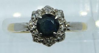 An 18ct gold ring set with a sapphire and diamonds, 2.8g, size J