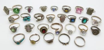 A collection of over 18 silver rings set with paste, turquoise, opal boulder etc