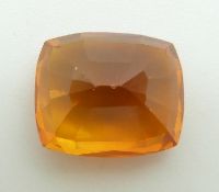 A loose cushion cut orange sapphire measuring approximately 6.85ct