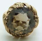 A 9ct gold textured ring set with a round cut smoky quartz, 10.1g, size N